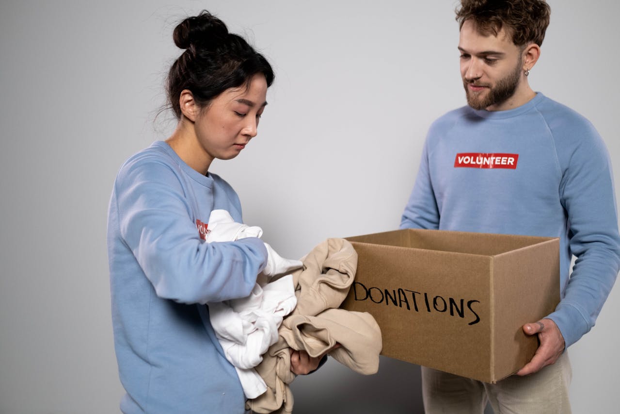 A lady donating her used clothes