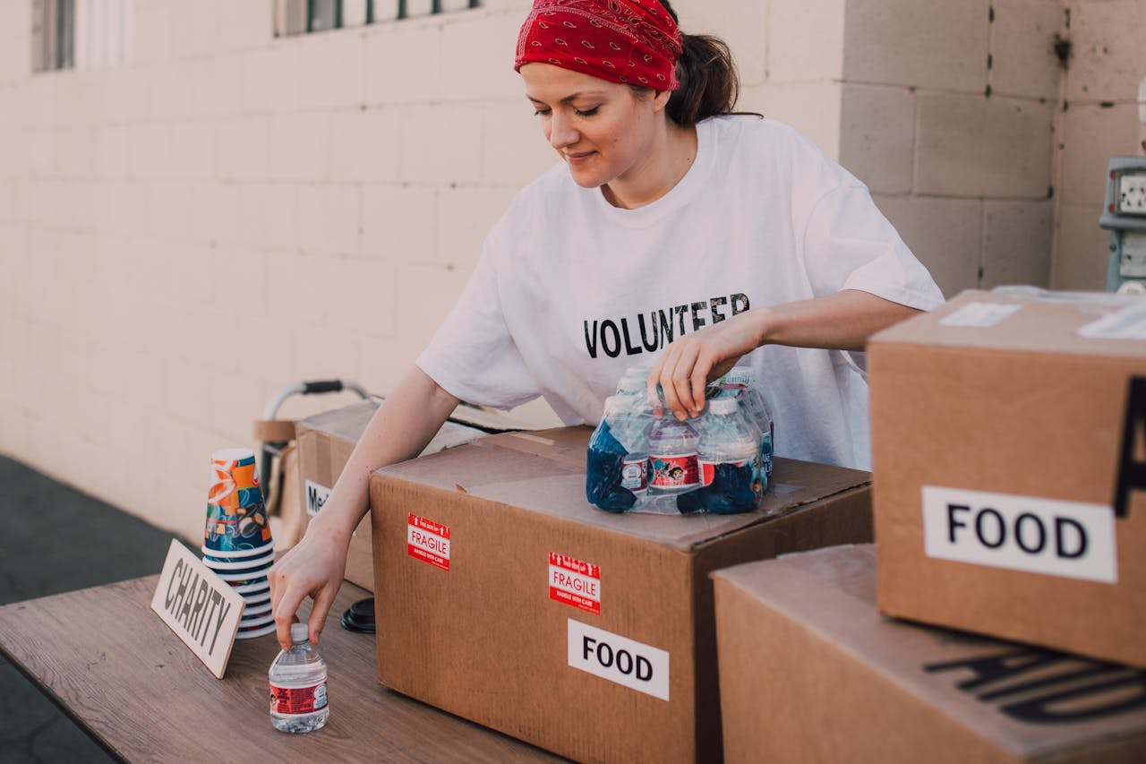 A lady arranging donated items at a charity event